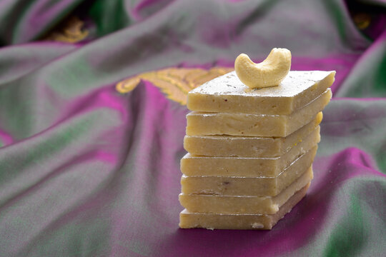 Closeup of kaju katli sweet on silk cloth