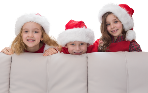 Digital png photo of three caucasian children behind couch, copy space on transparent background