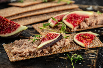 crispy rye bread with Liver pate and fig. vertical image. top view. place for text