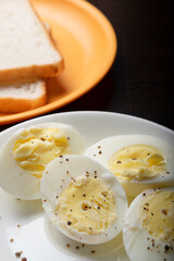 Closeup of boiled egg with bread on table