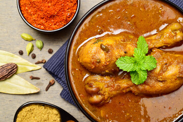 Top view of spicy chicken curry with whole spices