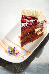 Black forest gateaux cake with a chocolate sponge, cherry compote, and Chantilly cream. Decorated...