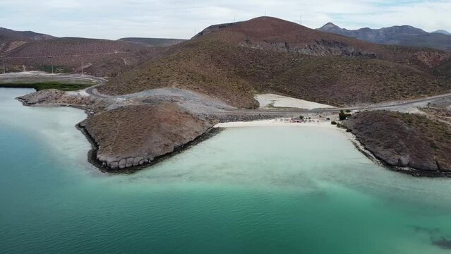 Aerial dolly shot of a gorgeous beach with turquoise sea at Playa El Tecolote in Baja California Sur Mexico during a dream trip