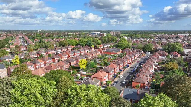 Drone descends treeline hiding typical English suburb of Doncaster England