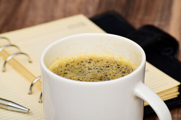 Closeup of black coffee mug at table