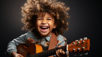 A joyful child playing guitar is isolated on a clean studio background with copy space. Creative banner for children's music school - obrazy, fototapety, plakaty