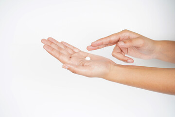 Applying moisturizer cream in hands on white background