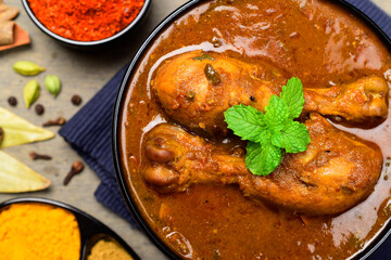 Top view of masala chicken curry in bowl, spicy indian style chicken