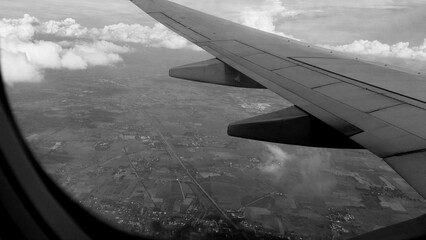 Monochrome airplane window background. Travel concept, traveler, trip, vacation, tourism, aerial...
