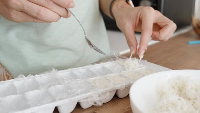 The Woman Is Filling an Ice Mold with Coconut Shavings for Candy Preparations.