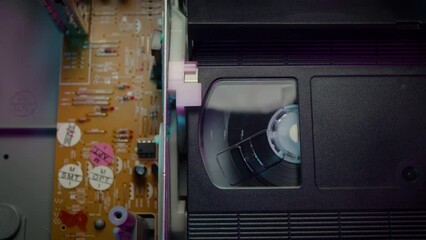 Retro Neon VHS Tape Playing in a VCR Dolly