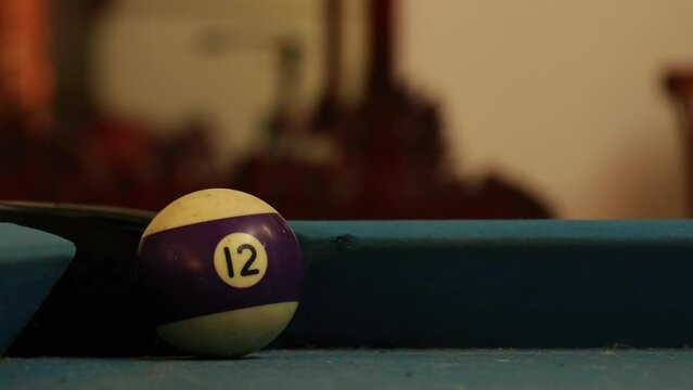 the billiard ball is hit and goes into the billiard hole.