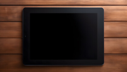 Black tablet on dark wooden surface.