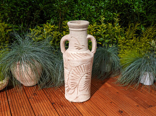 Ceramic Terracotta Amphora Clay Pot on veranda at green plants background