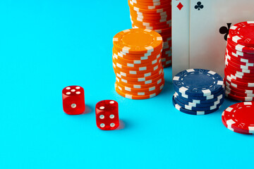 Playing cards and poker chips on blue background