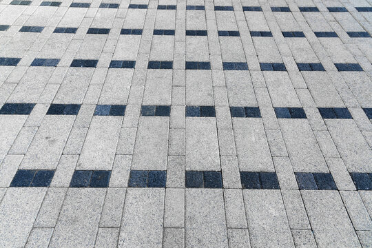 The texture of a monotonous tiled pavement with perspective.