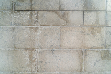 Texture concrete stone wall in cityscape. Abstract architectural detail in a textured tile concrete wall.