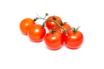 Red cherry tomatoes on a white background. Photo.