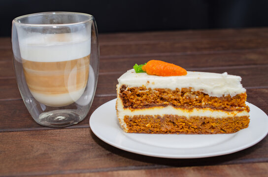 Carrot sponge cake with cream and walnuts and Cappuccino coffee