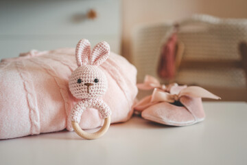 Handmade knitted rattle and baby pink blanket