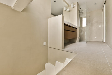 an empty bathroom with no one person in the photo, taken from the top floor to the wall and ceiling