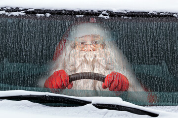 Santa Claus drives a snowy car