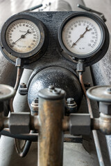 The historical pressure gauges on the torpedo service system, close up.