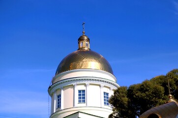 Golden dome of the Orthodox Church against the blue sky