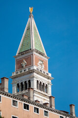Obraz premium Piazza San Marco with top of Campanile di San Marco with golden angel on top at City of Venice on sunny summer day.