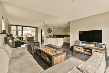 a living room with couches and a flat screen tv mounted on the wall in the room is very modern