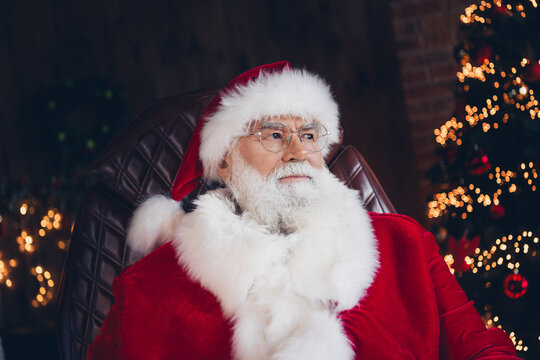 Photo of good mood thoughtful santa claus dressed red costume spectacles sitting office indoors north pole home - Powered by Adobe