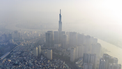 aerial view of early morning at Landmark 81 is a super tall skyscraper in center Ho Chi Minh City, Vietnam and Saigon bridge with development buildings, energy power infrastructure.