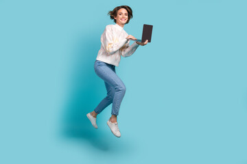 Full size photo of run hurry young woman holding laptop professional programmer deadline meet conference isolated on blue color background