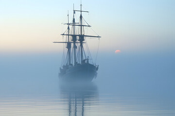 spectral ghost ship at foggy morning or evening. Neural network generated image. Not based on any actual person or scene.