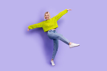 Fototapeta premium Full length photo of cool carefree woman dressed knitted sweater dancing having fun isolated violet color background