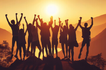 Big group of happy friends with raised hands at sunset. People's silhouettes. Unity, success, team or friendship concept