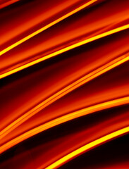 Light wave trail path, vibrant neon gold color in abstract swirls on a black background.