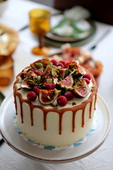Cake with cream and ripe berries and nuts