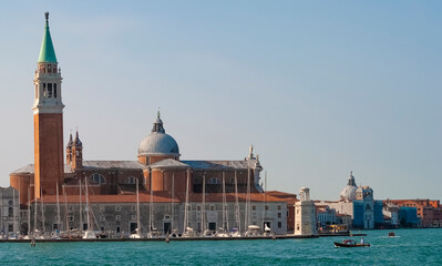 Fototapeta na wymiar San Giorgio Maggiore island in Venice, Italy. Beautiful view of San Giorgio Maggiore church, sky and mirror reflection in water. Skyline, panorama of old buildings in sea.