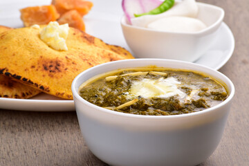 Closeup of mustard saag bowl at table