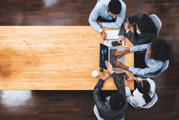 Panorama top view multiracial analyst team use BI dashboard display on laptop screen, analyzing financial data for strategic decision. Fintech analyzes marketing indicators. Concord