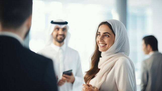 Dubai business woman talking with foreign business people in the white office