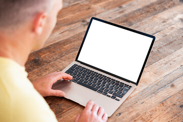 Man using laptop computer, blank white screen mockup