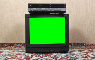 Old TV with a green screen and a VCR on the background of the wallpaper.