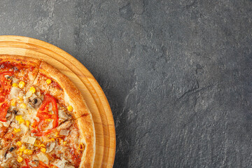 delicious pizza with chicken, mushrooms, cheese, tomatoes and corn on a concrete background - Powered by Adobe