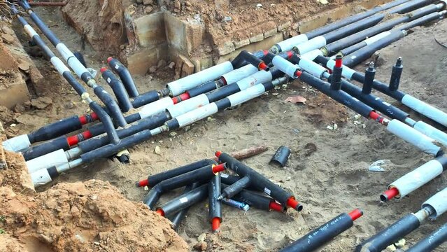 Laying a heating main pipe system underground. Replacement of old heating main pipes with new insulated pipes, industry