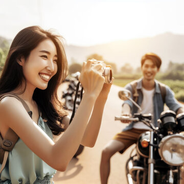Smiling woman photographing friend next to motorcycles on sunny rural road