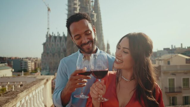 Young multiethnic couple dating for a romantic dinner on a beautiful balcony in Barcelona
