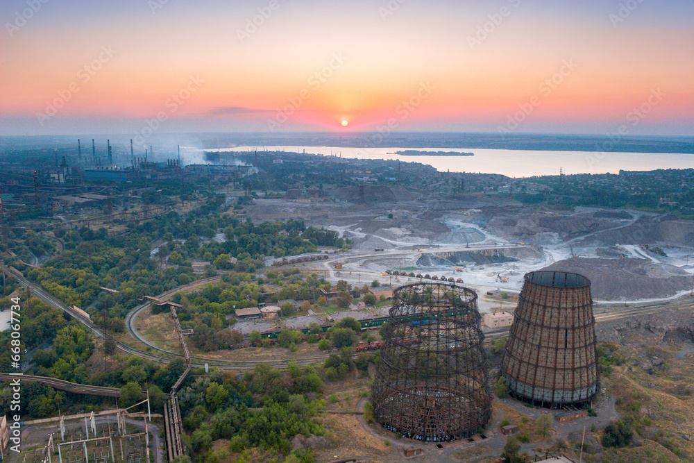 Wall mural aerial view of industrial area with metallurgical plants and cooling towers on sunset