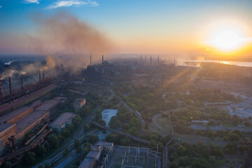 Industrial landscape with metallurgical plants on sunset